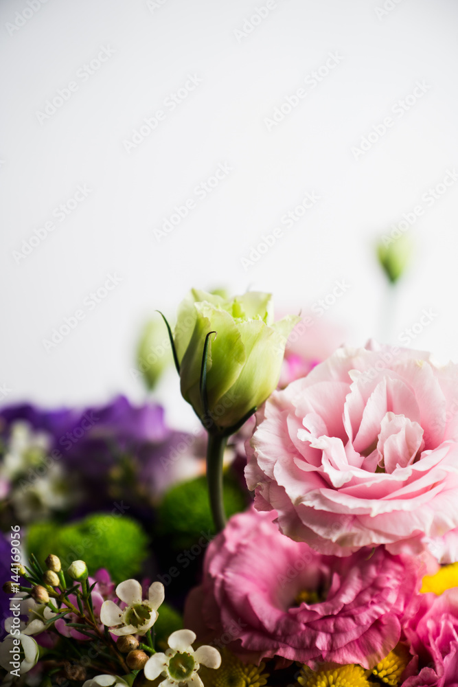 Obraz premium Bouquet with a lot of different flower on the wooden background. Shallow depth of field.