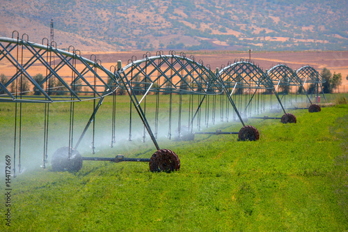 Photography An irrigation pivot watering a flower field