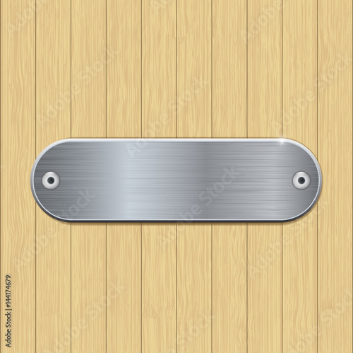 Metal brushed plate on wooden wall