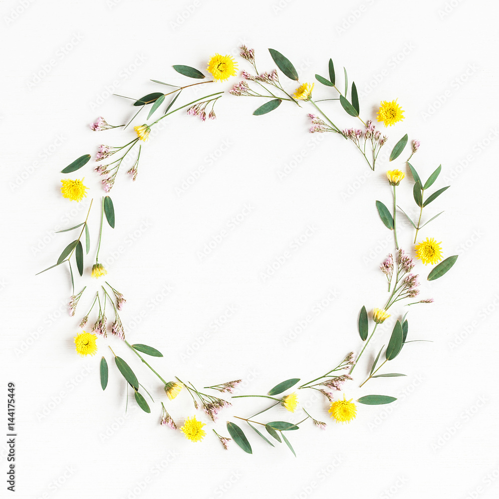 Flowers composition. Wreath made of yellow flowers and eucalyptus leaves on white background. Flat lay, top view