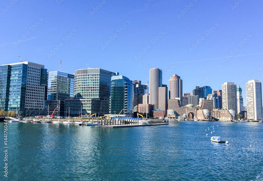 BOSTON - OCTOBER 2015: City port and buildings on a sunny day. Boston attracts 10 million people annually