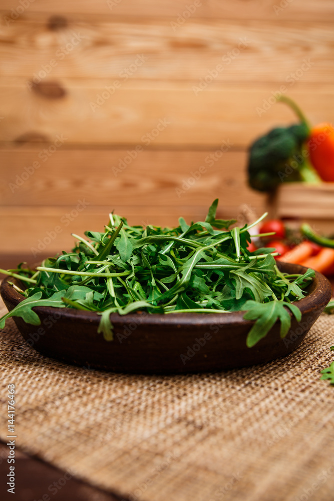 Green arugula leaves in bowl. Fresh salad. Green arugula leaves in bowl. Fresh salad.