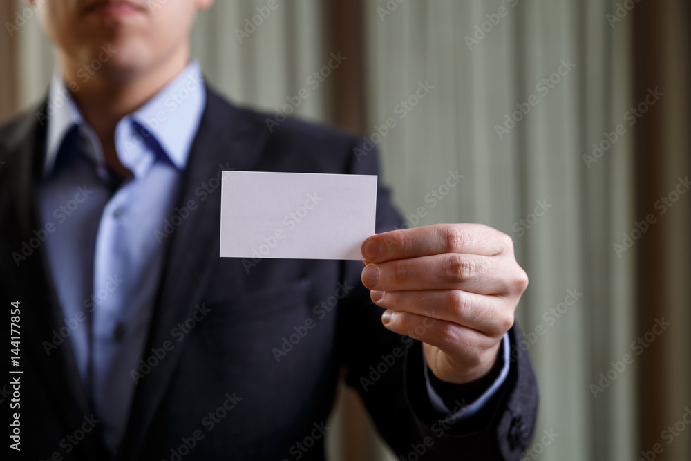 Businessman holding visit or business card.