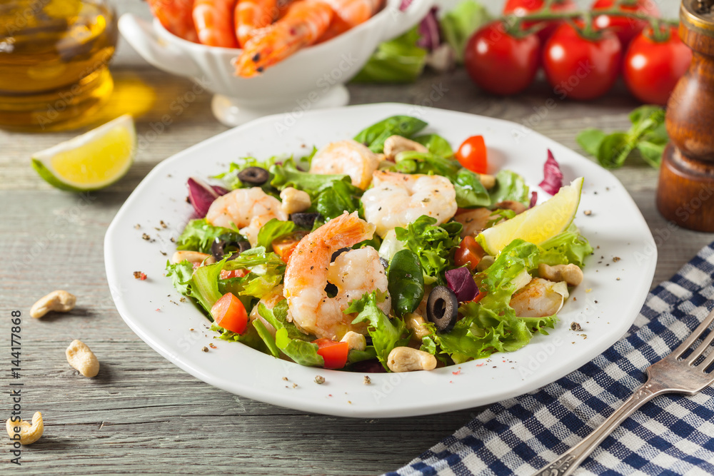 Shrimp salad with tomato, olives and cashew nuts.