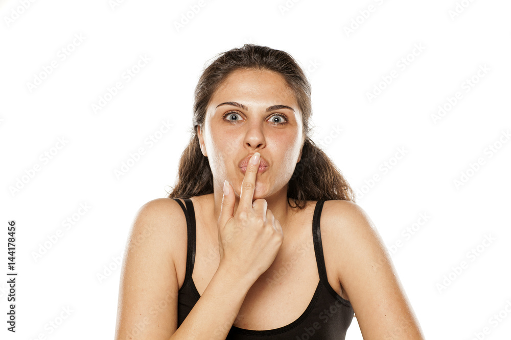 young beautiful woman kisses her finger young beautiful woman kisses her finger