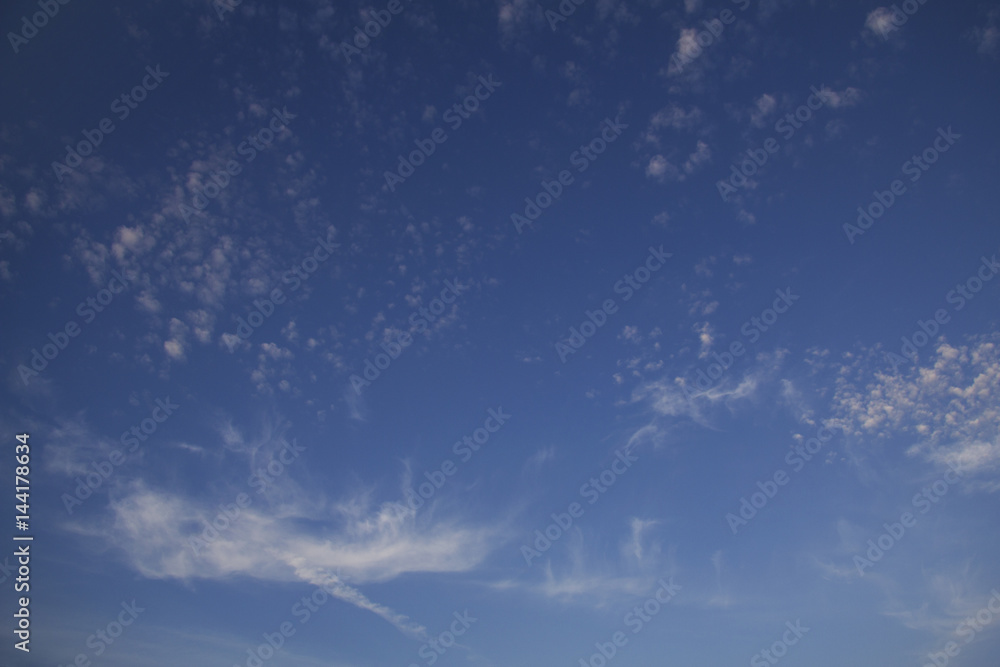 Background. Rare bright clouds in the shape of a flower on a blue sky at sunset in late summer. Background. Rare bright clouds in the shape of a flower on a blue sky at sunset in late summer.