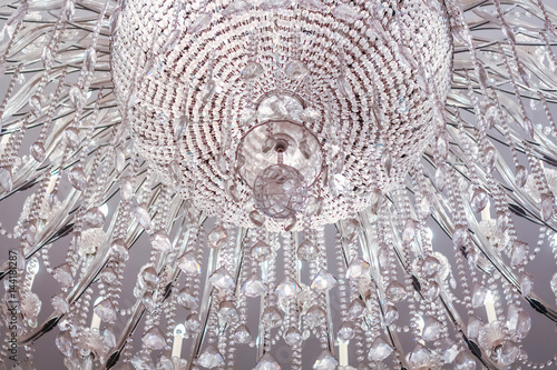 Closeup of chandelier crystal light on a ceiling photo