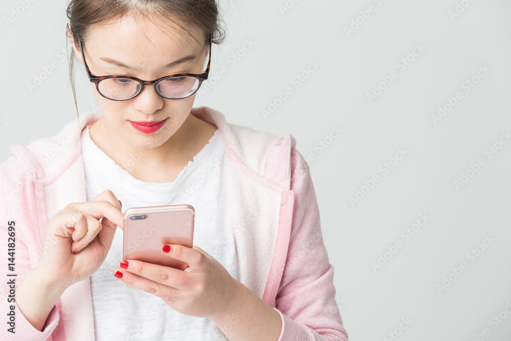 Portrait of beautiful young woman playing her mobile phone. Portrait of beautiful young woman playing her mobile phone.