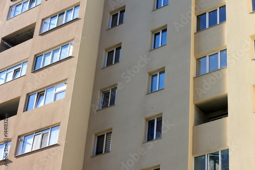Facade of a beautiful multi-storey modern building with windows and balconies close-up