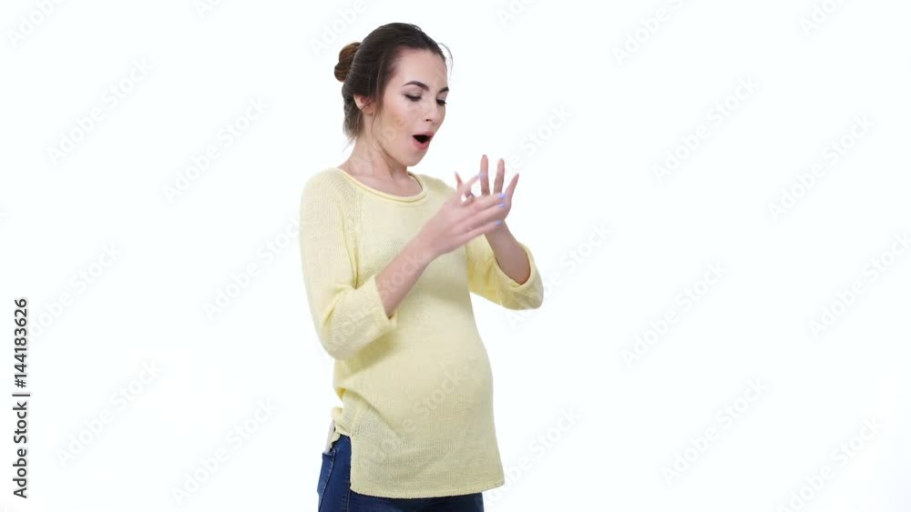 Attractive young pregnant woman getting a box with engagement ring and putting it on her finger isolated over white Attractive young pregnant woman getting a box with engagement ring and putting it on her finger isolated over white