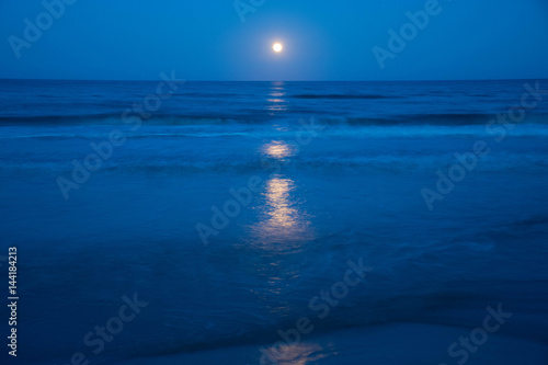 Sunset and the moon rising on the Mediterranean coast in southern Spain