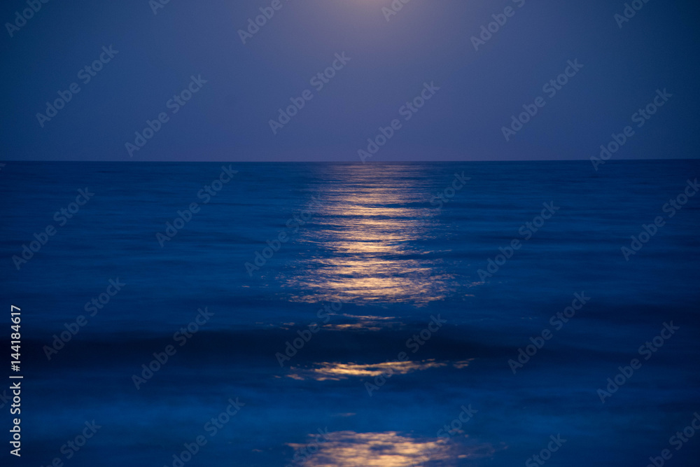 Sunset and the moon rising on the Mediterranean coast in southern Spain