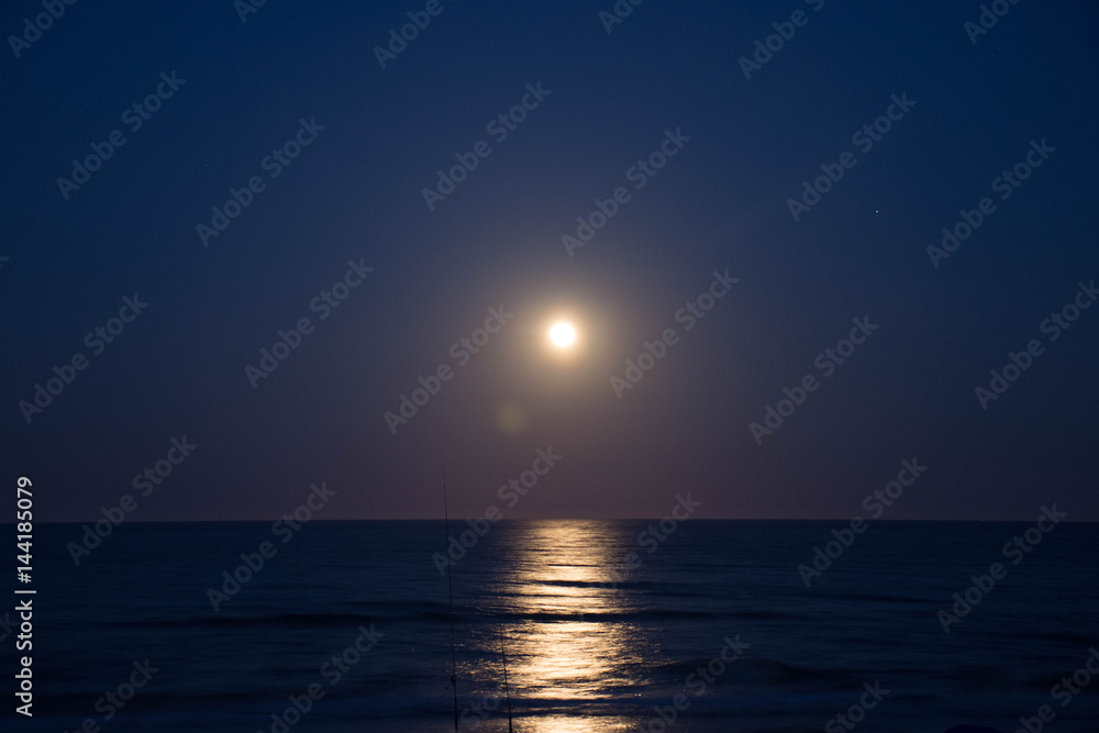 Fototapeta premium Sunset and the moon rising on the Mediterranean coast in southern Spain