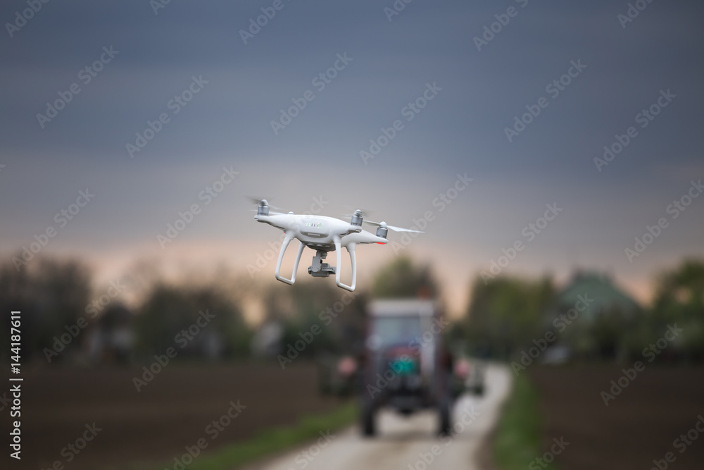 Drone flying in front of tractor Drone flying in front of tractor