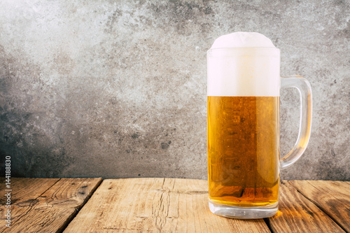 Glass of beer on wooden table. wallpaper with copy space