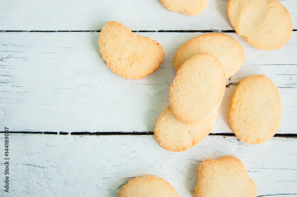 A group of butter shortbread cookies on white wooden background. Selective focus. Close up and copy space.