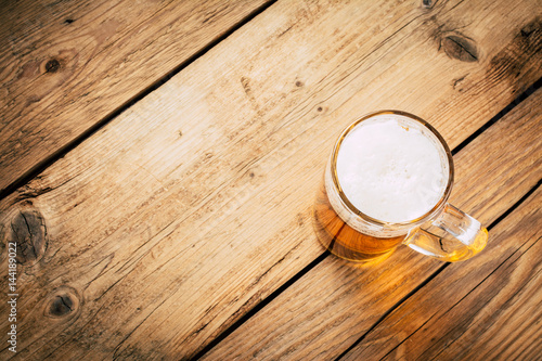 Glass of beer on wooden table. wallpaper with copy space