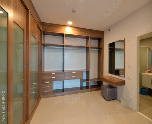 Fotografiet wooden carbinets in dressing room in modern home, interior design