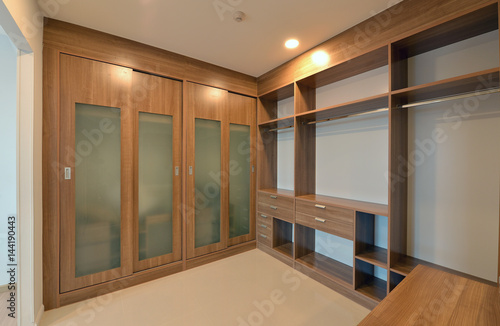 Canvastavla wooden carbinets in dressing room in modern home, interior design