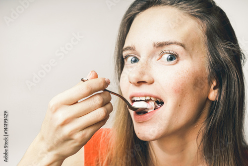 Eating woman with pleasure yogurt close eyes