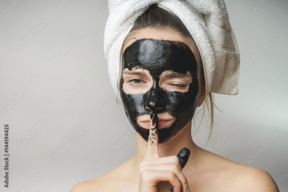 Φωτογραφία Woman skin care,cosmetics black mask on face.Towel on head