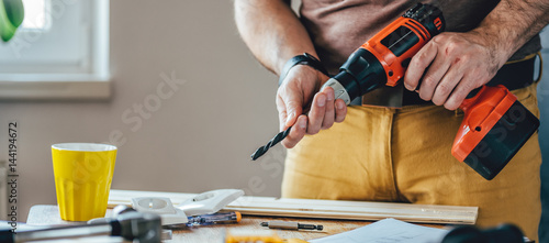Naklejka Man using cordless drill
