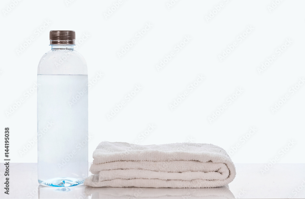 Bottle of water and towel,isolated on white background wiith clipping path. Bottle of water and towel,isolated on white background wiith clipping path.