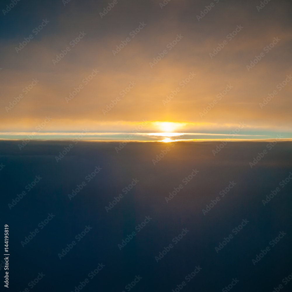 Obraz premium View of the sunrise and the clouds from within, out of the plane