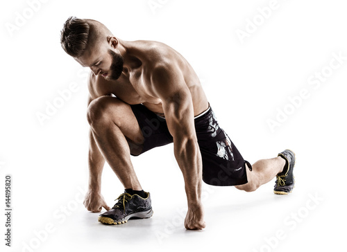 Runner stretching. Man does exercise for stretching muscles. Photo of sporty man working on white background