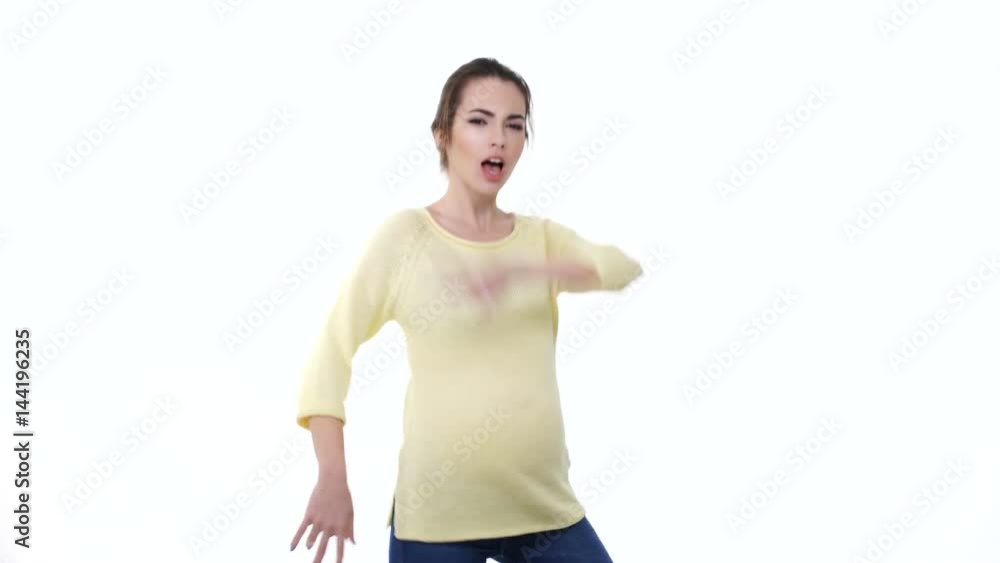Young active pregnant woman dancing and having fun isolated over white Young active pregnant woman dancing and having fun isolated over white