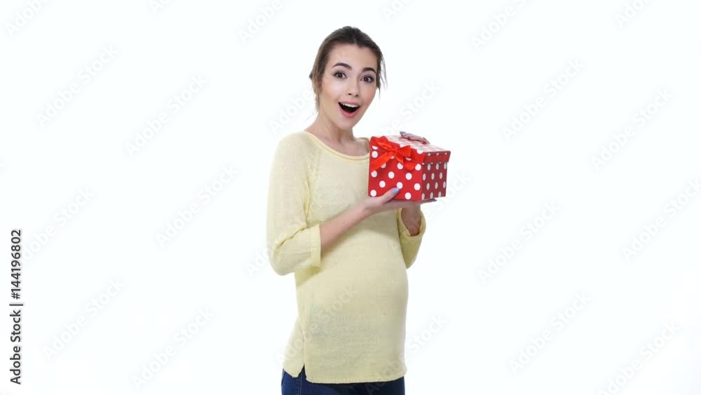 Happy cheerful young pregnant woman is opening gift box isolated over white Happy cheerful young pregnant woman is opening gift box isolated over white