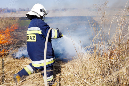 Firefighter fights grass fires. Polish firefighter.