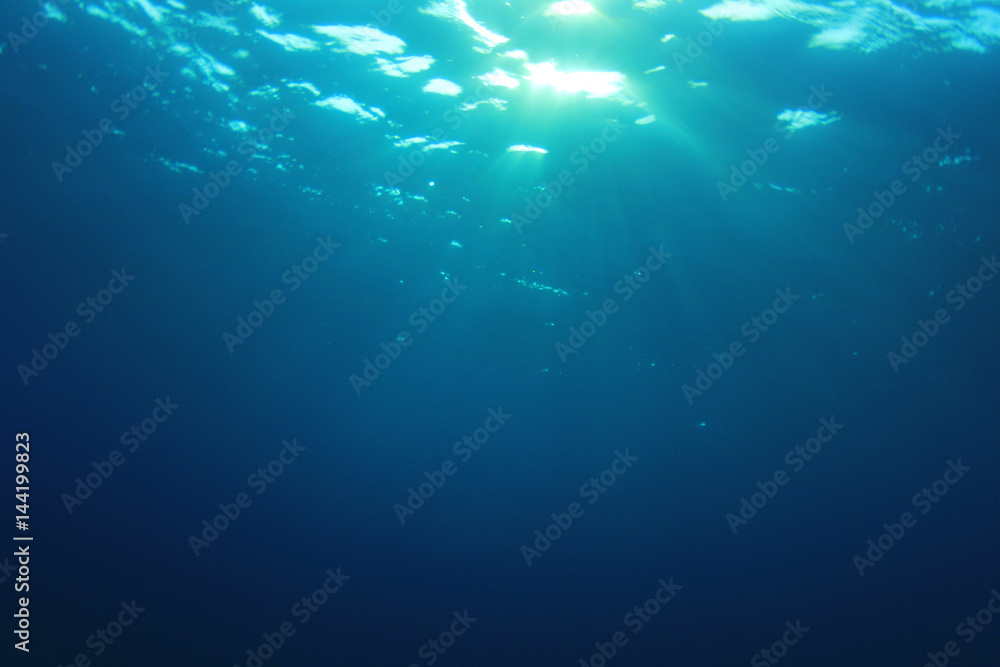 Underwater blue ocean background with sunlight 
