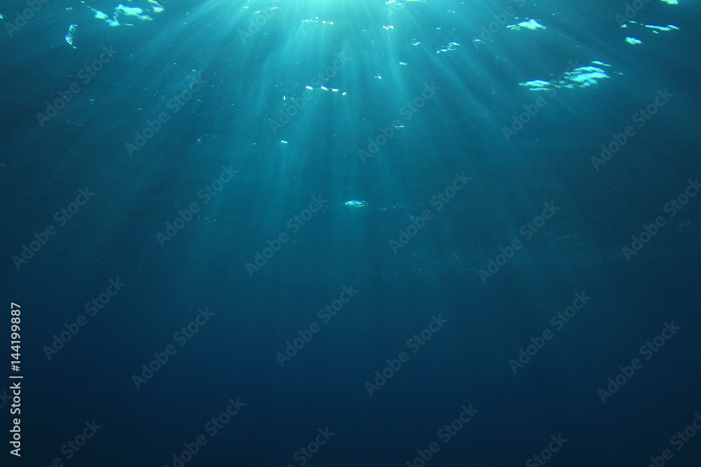 Underwater blue ocean background with sunlight Underwater blue ocean background with sunlight