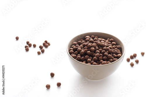 Bowl of cocoa cereals on white background