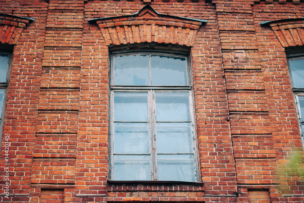 Three window on a red bric wall Three window on a red bric wall