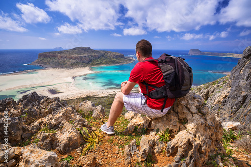 Fotografie Man with backpack watching beautiful Balos beach on Crete, Greece
