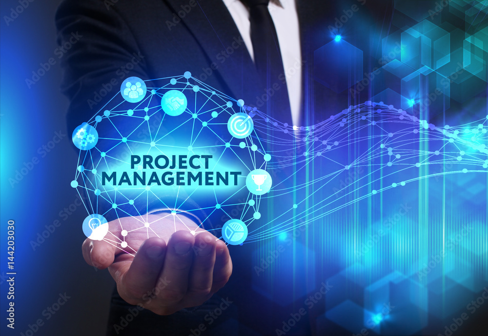 Business, Technology, Internet and network concept. Young businessman working on a virtual screen of the future and sees the inscription: Project management Business, Technology, Internet and network concept. Young businessman working on a virtual screen of the future and sees the inscription: Project management