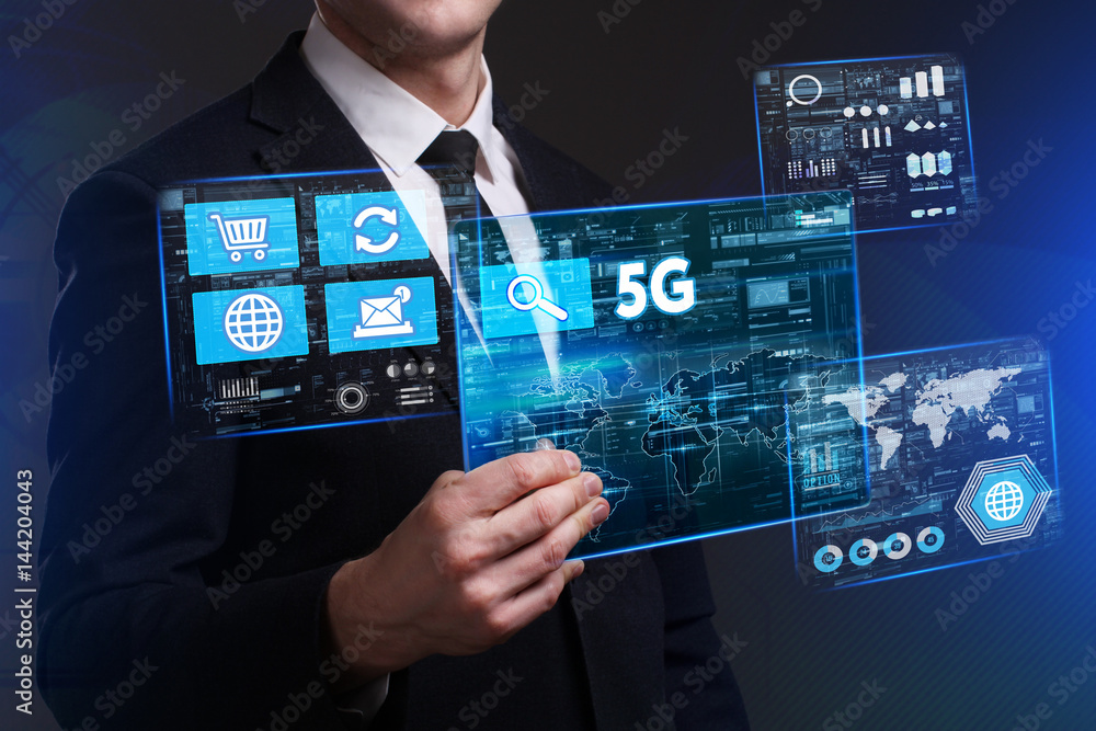 Business, Technology, Internet and network concept. Young businessman working on a virtual screen of the future and sees the inscription: 5G Business, Technology, Internet and network concept. Young businessman working on a virtual screen of the future and sees the inscription: 5G