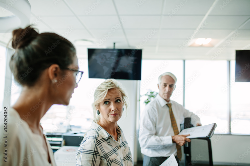 Business people having a informal meeting in modern office Business people having a informal meeting in modern office