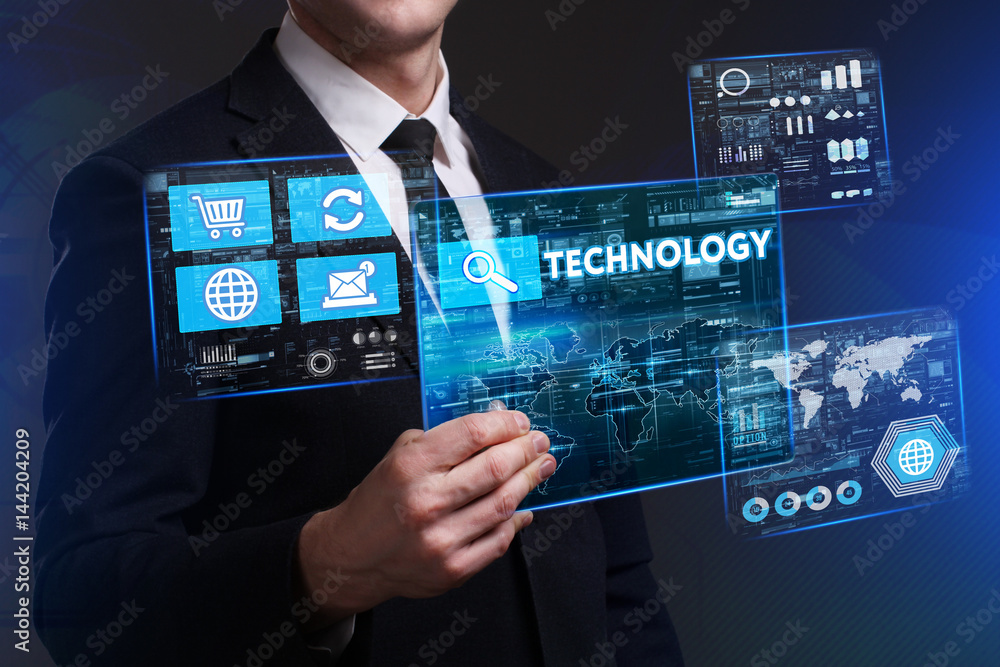 Business, Technology, Internet and network concept. Young businessman working on a virtual screen of the future and sees the inscription: Technology Business, Technology, Internet and network concept. Young businessman working on a virtual screen of the future and sees the inscription: Technology