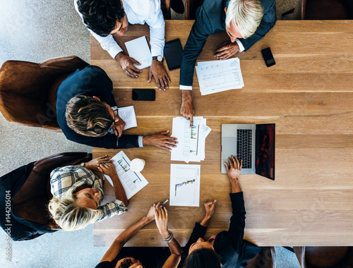 Team of business people sitting together in discussion