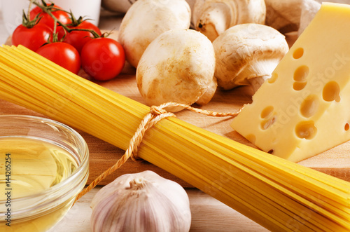 Pasta ingredients. Cherry-tomatoes, spaghetti pasta, garlic, cheese and mushrooms