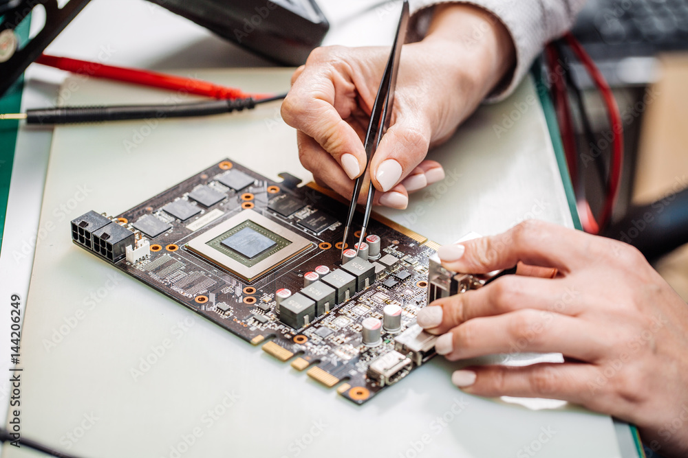 woman repairing computer hardware in service center. Repairing and fixing service in lab. Electronics repair service concept. woman repairing computer hardware in service center. Repairing and fixing service in lab. Electronics repair service concept.