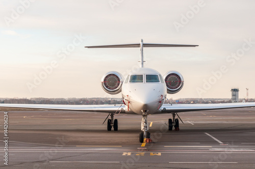Luxury business jet stands at the airport and ready for boarding. Private aircraft front view