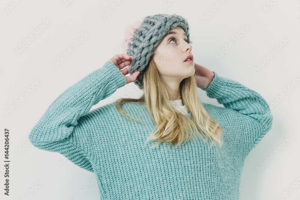 Pretty young girl with blond hair in fashionable sweater, hat Pretty young girl with blond hair in fashionable sweater, hat
