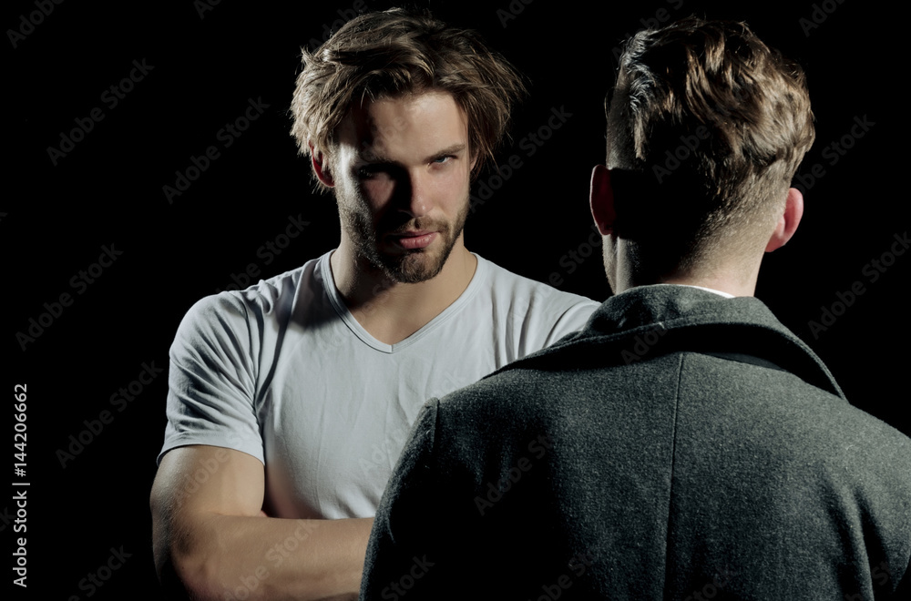 Obraz premium Two handsome men standing with faces opposite