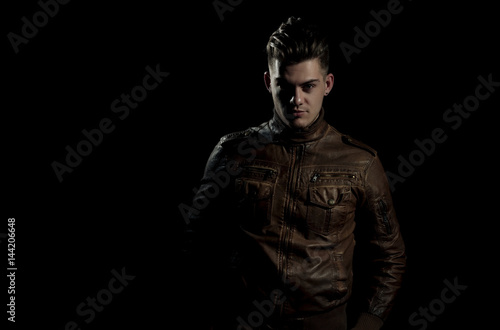 Handsome man posing in brown, leather jacket