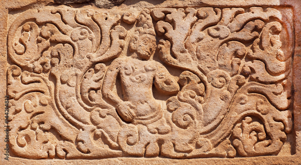Example of Indian design of stone relief of 7th century temple in Pattadakal, India. UNESCO World Heritage site with stone carved temples.