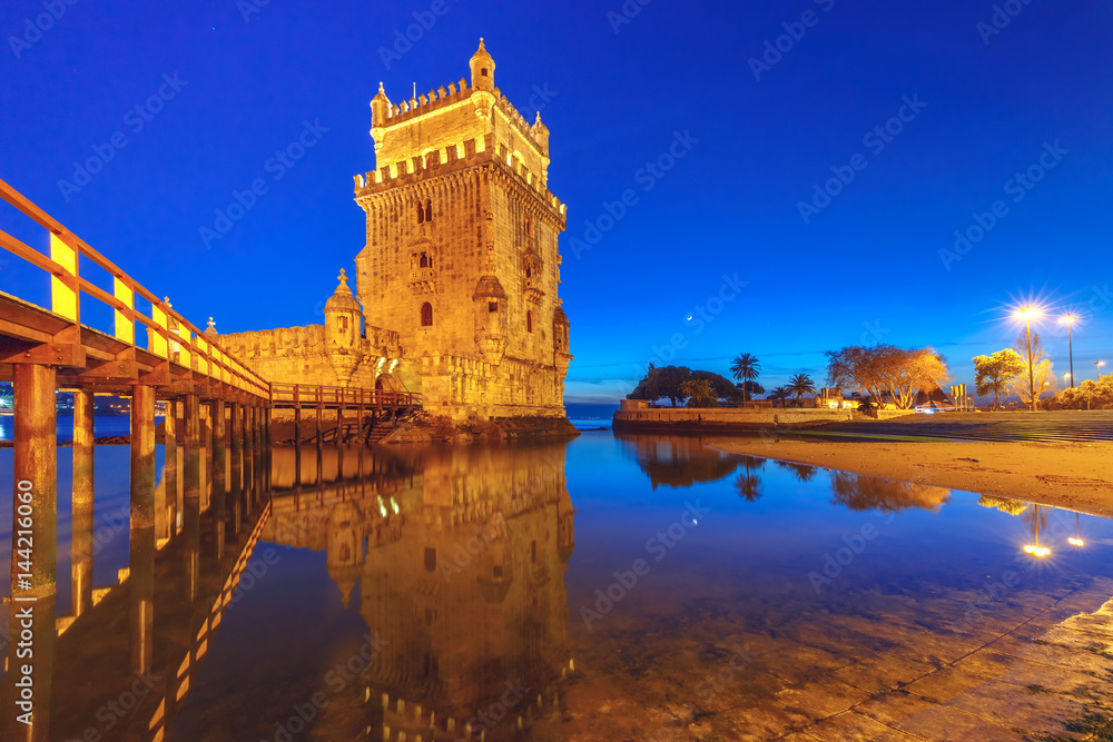 Belem Tower or Tower of St Vincent on the bank of the Tagus River during evening blue hour, Lisbon, Portugal